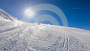 Goldeck - A snowboarding girl going down the slope