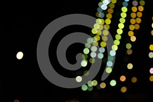 Golden abstract yellow, orange bokeh lights isolated on black background with copy space. Holiday and Christmas season concept,