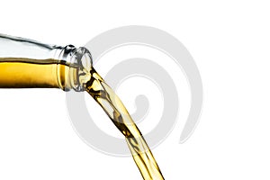 Golden ale pouring from clear bottle isolated on white background