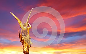 Golden angel over beautiful sky