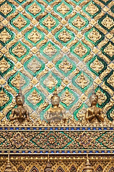 Golden angel statue and decorated wall with thai art