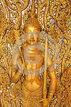 Golden angel in on the wall of temple.