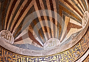 golden Arabic calligraphy on ceiling of a mosque