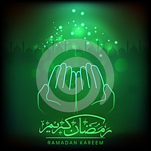 Golden Arabic Calligraphy Of Ramadan Kareem with Islamic Human Open Hands for Praying on Green Light Effect Silhouette Mosque