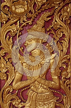 The golden art in the wood door at temple.