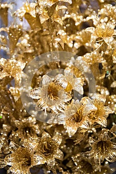 Golden artificial flowers for Christmas decorations.