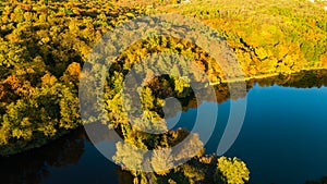 Golden autumn background, aerial drone view of forest with yellow trees and beautiful lake landscape from above, Kiev