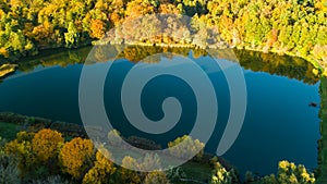 Golden autumn background, aerial drone view of forest with yellow trees and beautiful lake landscape from above, Kiev