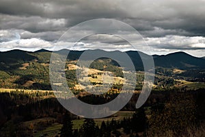 Golden autumn in the Carpathians. Mining arrays combined with trees with yellow leaves. Beautiful clouds and sun