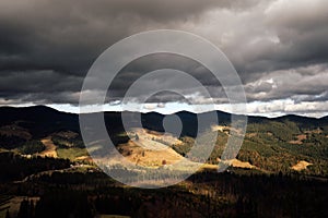 Golden autumn in the Carpathians. Mining arrays combined with trees with yellow leaves. Beautiful clouds and sun