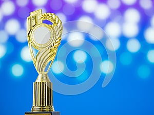 Golden award winning trophy with abstract bokeh photo