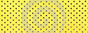 Golden background from metal foil paper with pattern of stars closeup. Texture of yellow metallized backdrop