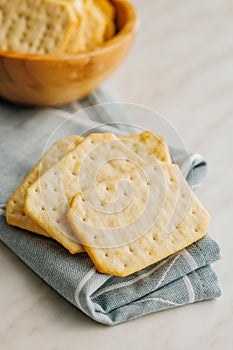 Golden Baked Crackers on napkin on a White kitchen table