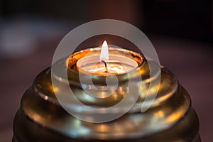 Golden ball candle flaming in the dark