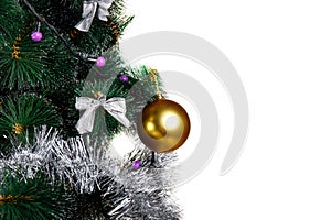 Golden ball hanging on a branch of a Christmas tree, isolated on white.