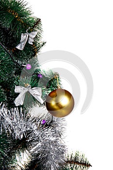 Golden ball hanging on a branch of a Christmas tree, isolated on white.