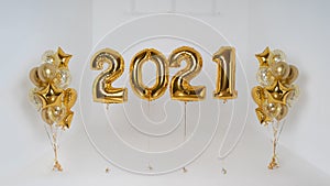 Golden balloons numbers date 2021 filled with helium and party balloons on the side on ribbon isolated on white