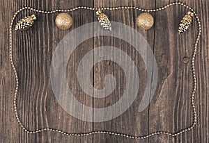 Golden baubles on wooden background