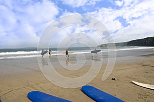 Golden beach with children going to surf