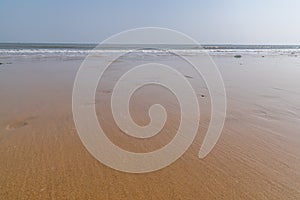 The golden beach after the sea recedes, the sand is very fine and soft photo