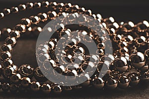 Golden beads necklace on dark background