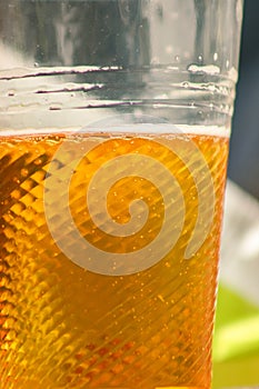 Golden beer, ale or lager in a plastic disposable cup
