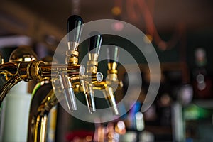 Golden beer tap with blurred background