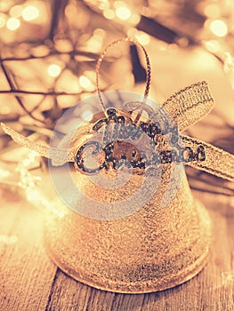 Golden bell for Christmas decoration on dark wooden background i