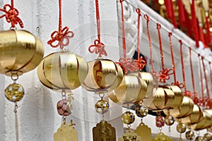 Golden bell donation and writing name for luck hanging on wall in Xuanguang Temple sun moon lake
