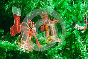 Golden bells and sock ornament on Christmas Tree