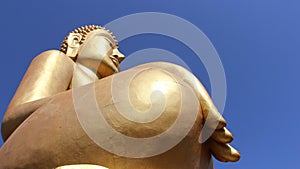 Golden big buddha with Blue sky background in sunny day