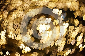 Golden big and small hearts bokeh. Beautiful valentines day background