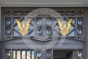 Golden bird decoration on transom above the front door in Spain