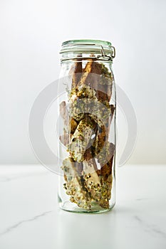 Golden Biscotti or Cantuccini on white plate on the white marble background.Traditional Sweet Italian cookies, two times