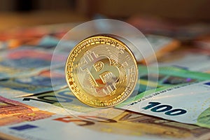 Golden bitcoin BTC on euro banknotes