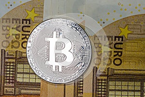 Golden Bitcoin close-up . Cryptocurrency. Euro banknote background
