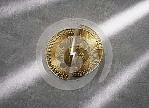 A golden Bitcoin coin split in half on concrete background, concept of Halving, an event that occurs in btc approximately every