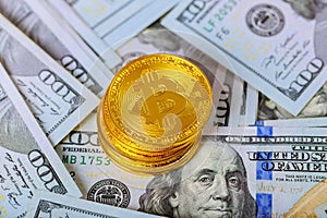 golden bitcoin coin on us dollars close up. Electronic crypto currency