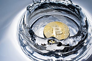 golden bitcoin coin with water splash crypto currency background