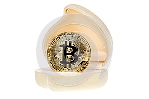 Golden Bitcoin coin in wedding ring box isolated on white background. Close up image. Crypto currency electronic virtual money for