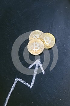 Golden bitcoin coins on a dark background with reflection. Virtual currency. Crypto currency. New virtual money. Lens flare