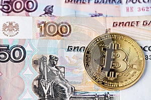 Golden Bitcoin cryptocurrency on Russian Rubles banknotes.