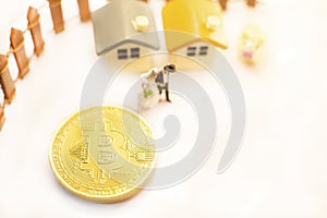 Golden Bitcoin cryptocurrency token coin bring happy financial freedom life to miniature couple people. Investment Success leads t
