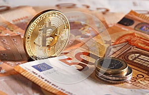 Golden bitcoin on fifty euro banknotes background. Bitcoin crypto currency, Blockchain technology, digital money, Mining concept,