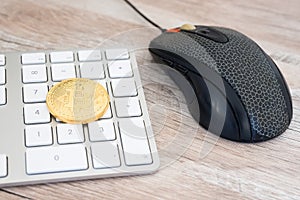 Golden bitcoin on a keyboard