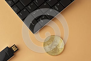 Golden bitcoin, keyboard and flash drive top view