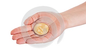 Golden Bitcoin in a man hand. Digitall symbol of a new virtual c