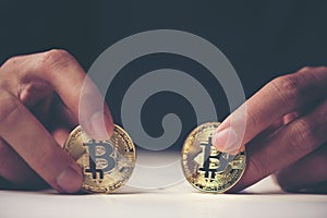 Golden Bitcoin in a man hand, Digitall symbol of a new virtual c