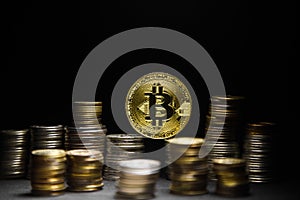 Golden bitcoin with money coins background. Bitcoin on black background photo