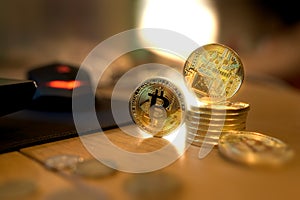 Golden Bitcoin money lies on the wooden table
